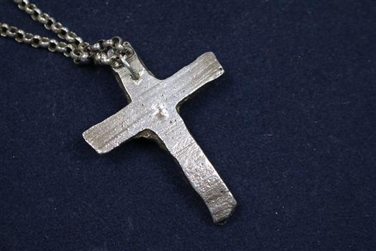 A 1970s white metal and emerald set cross pendant, on a silver belcher link chain, pendant 65mm.